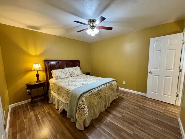 a bedroom with a bed and a ceiling fan