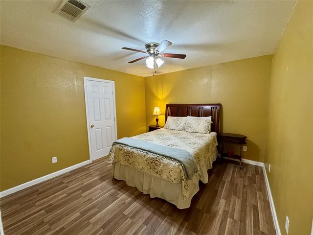 a bedroom with a bed and a ceiling fan