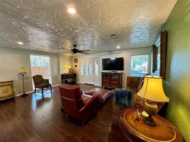 a living room with furniture and a flat screen tv