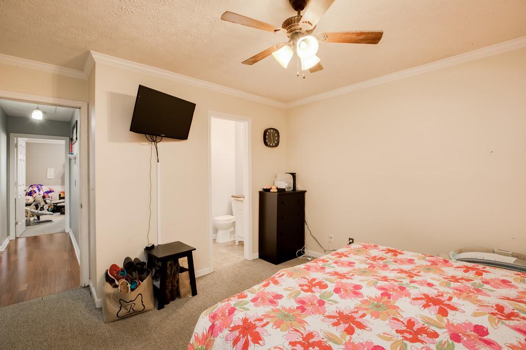430 Walton Ferry Road, Unit 200 Hendersonville, TN 37075 - Photo 21 of 28 a bedroom with a bed and a chandelier