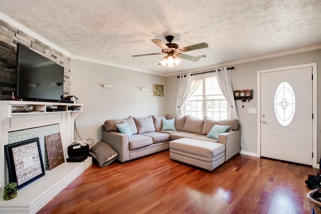 430 Walton Ferry Road, Unit 200 Hendersonville, TN 37075 - Photo 5 of 28 a living room with furniture a fireplace and a flat screen tv