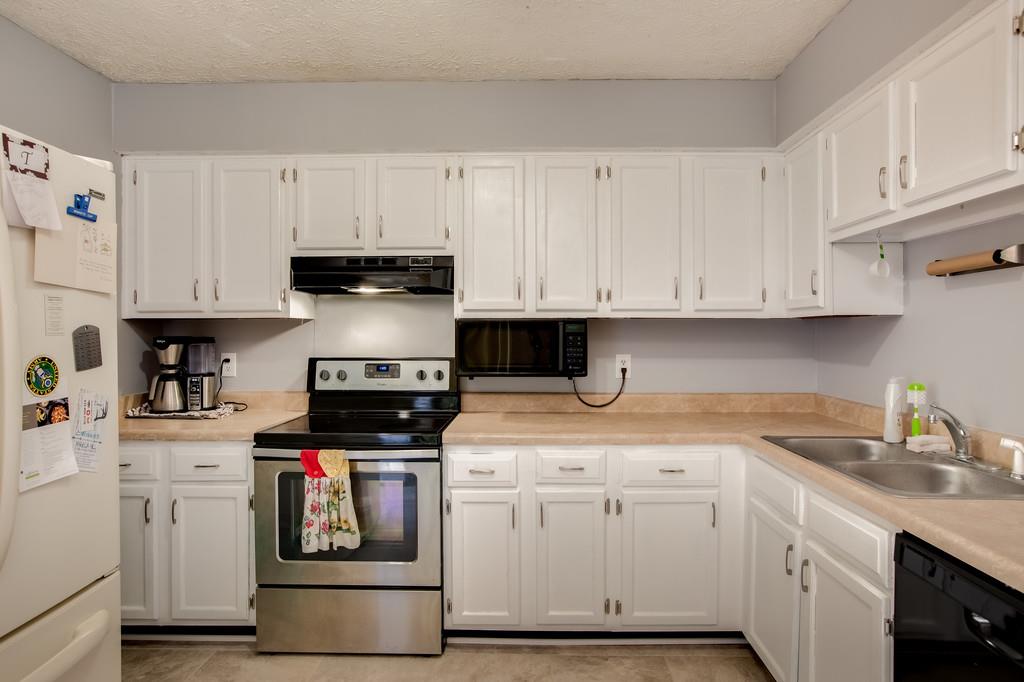 430 Walton Ferry Road, Unit 200 Hendersonville, TN 37075 - Photo 9 of 28 a kitchen with white cabinets and appliances