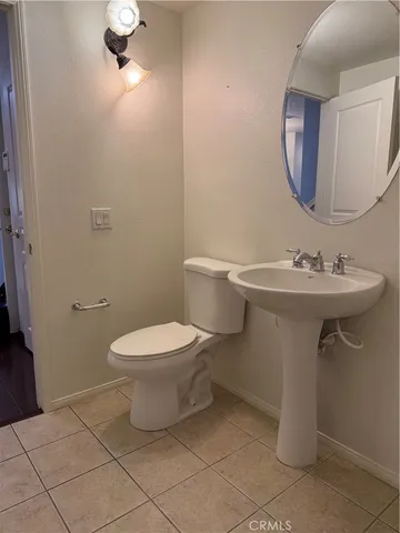 a bathroom with a sink toilet and a mirror