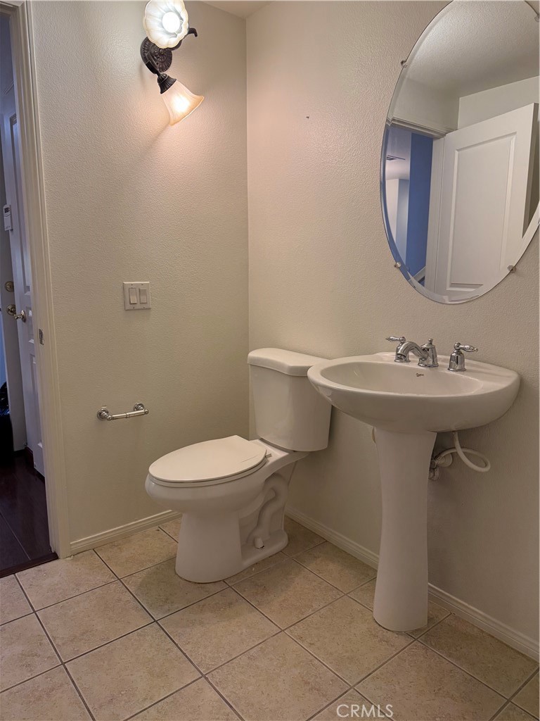12268 Chantrelle Drive Rancho Cucamonga, CA 91739 - Photo 6 of 12 a bathroom with a sink toilet and a mirror
