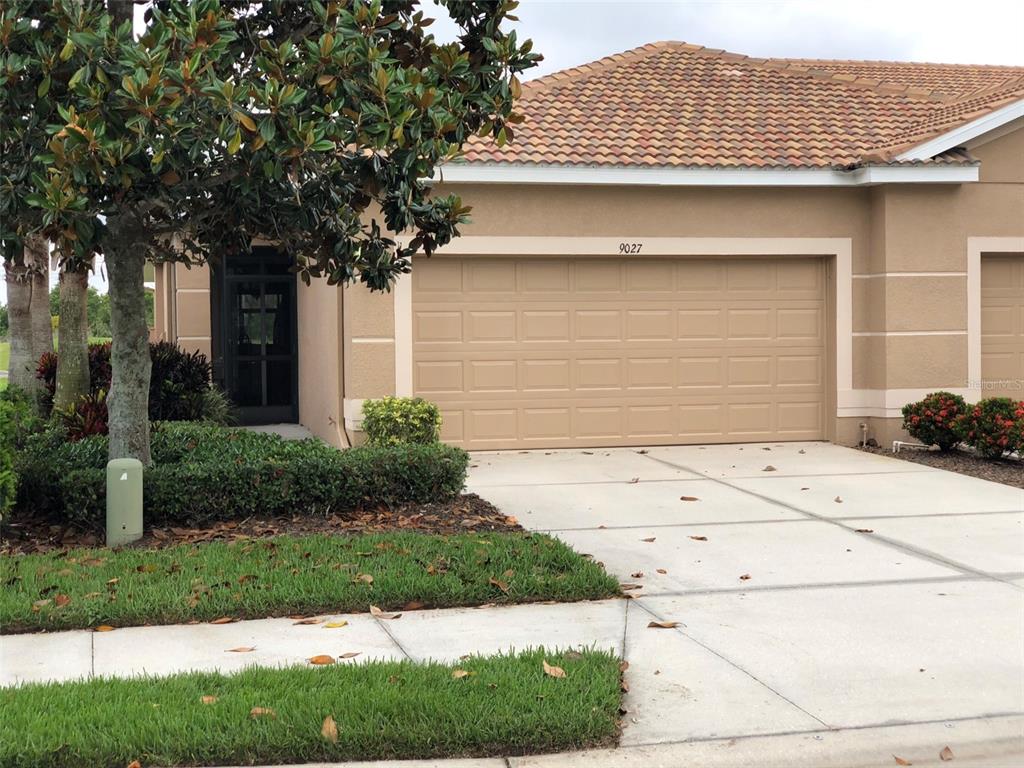 9027 Stone Harbour Loop Bradenton, FL 34212 - Photo 1 of 1 a front view of a house with a yard