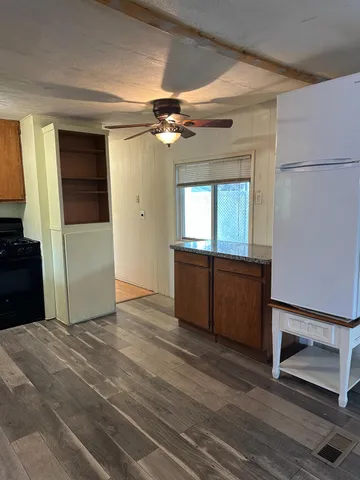 a view of an empty room with a kitchen