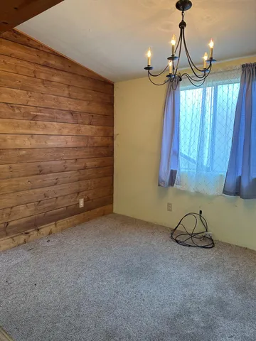 a room with a hanging chair and a window