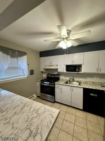 a kitchen with stainless steel appliances granite countertop a sink and cabinets