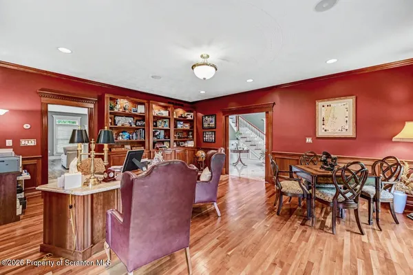 a view of a dining room with furniture a chandelier and wooden floor