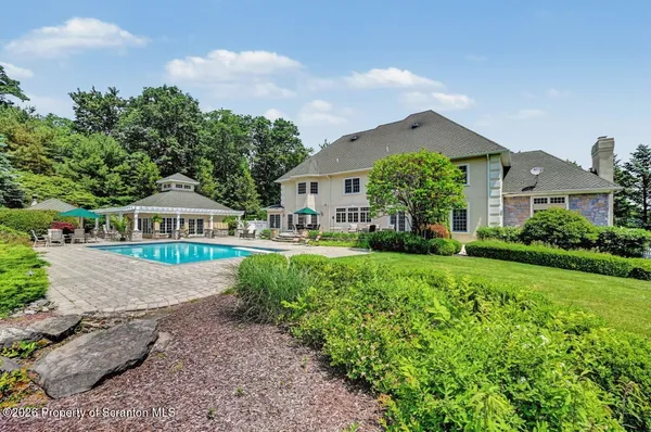 a view of a house with swimming pool and yard