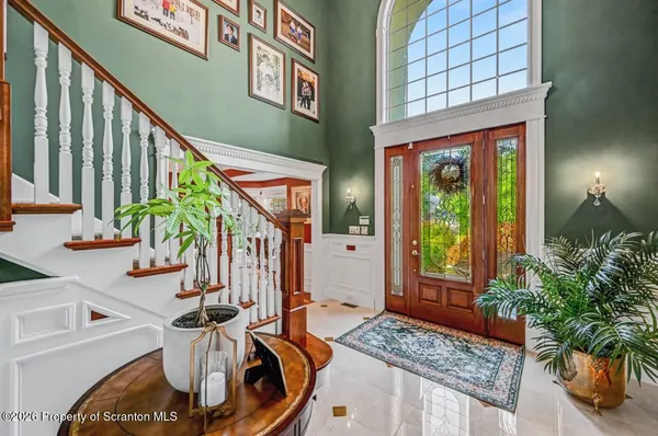 a dining room with furniture a chandelier and window
