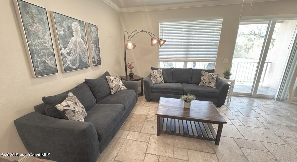 2709 Cutlass Point Lane, Unit 103 Merritt Island, FL 32953 - Photo 6 of 31 a living room with furniture and a large window