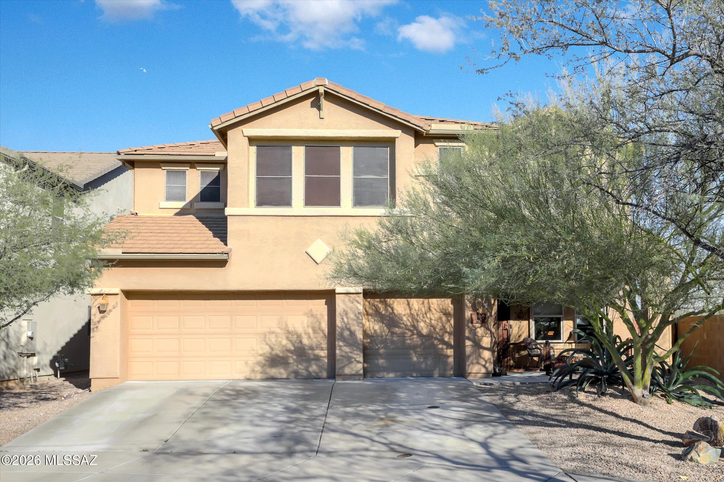 6095 South Jakemp Trail Tucson, AZ 85747 - Photo 1 of 52 a front view of a house with a yard