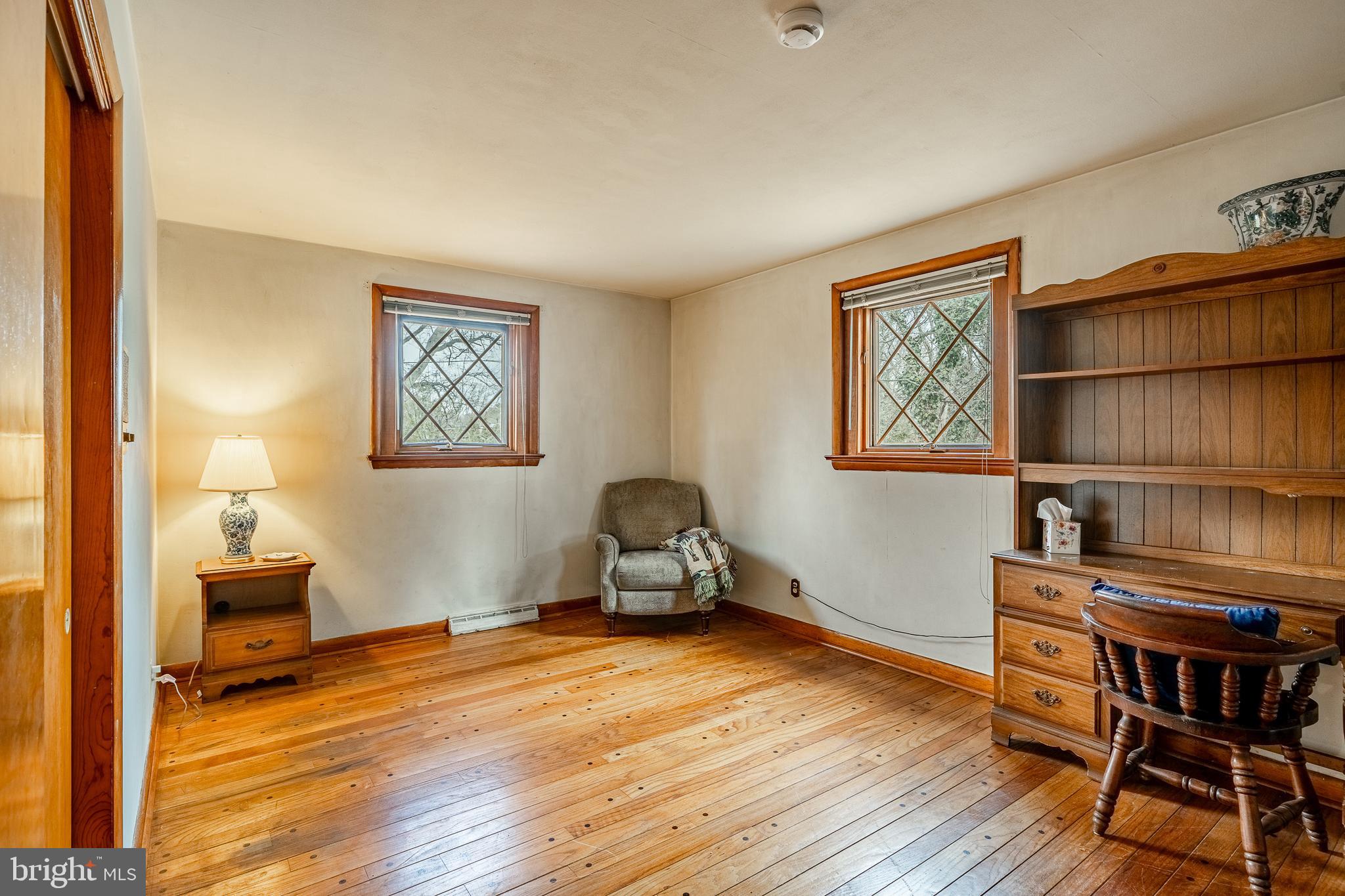 140 Ashley Road Newtown Square, PA 19073 - Photo 21 of 44 a bedroom with furniture window and wooden floor