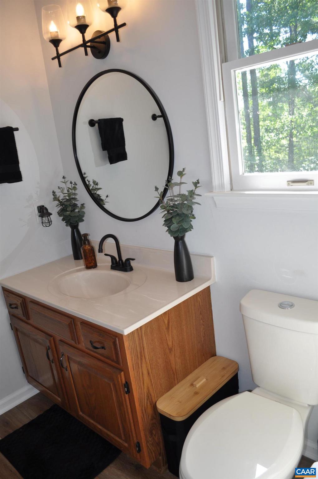 3257 Martin Kings Road Charlottesville, VA 22902 - Photo 21 of 49 a bathroom with a toilet a sink and mirror