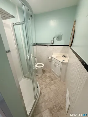 a white toilet sitting next to a small sink