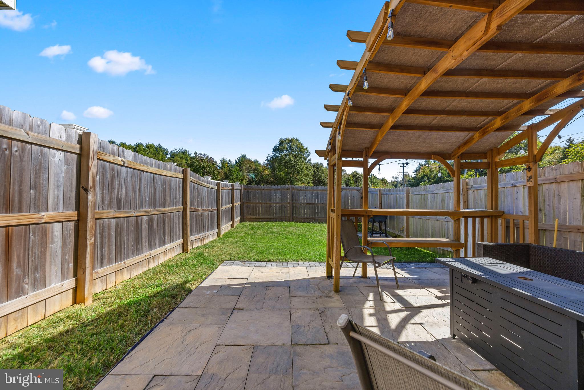 403 Dryden Road Aberdeen, MD 21001 - Photo 29 of 44 a view of a backyard with couches plants and wooden fence