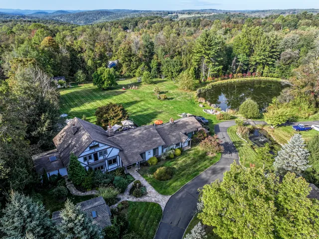 an aerial view of a house with a yard
