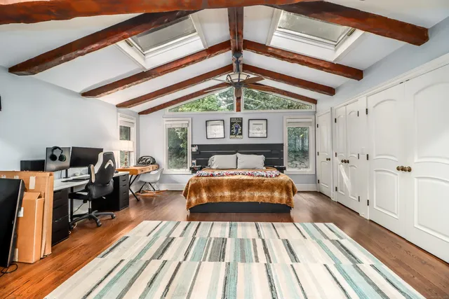 a bed sitting in a bedroom next to a window