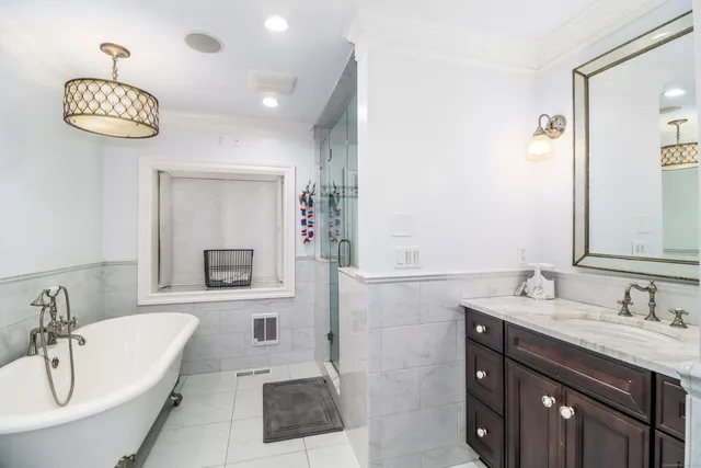 a bathroom with a sink a tub and a mirror
