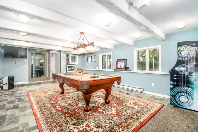 a living room with a pool table and a couch