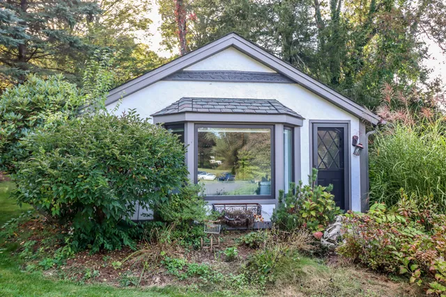 a front view of a house with garden