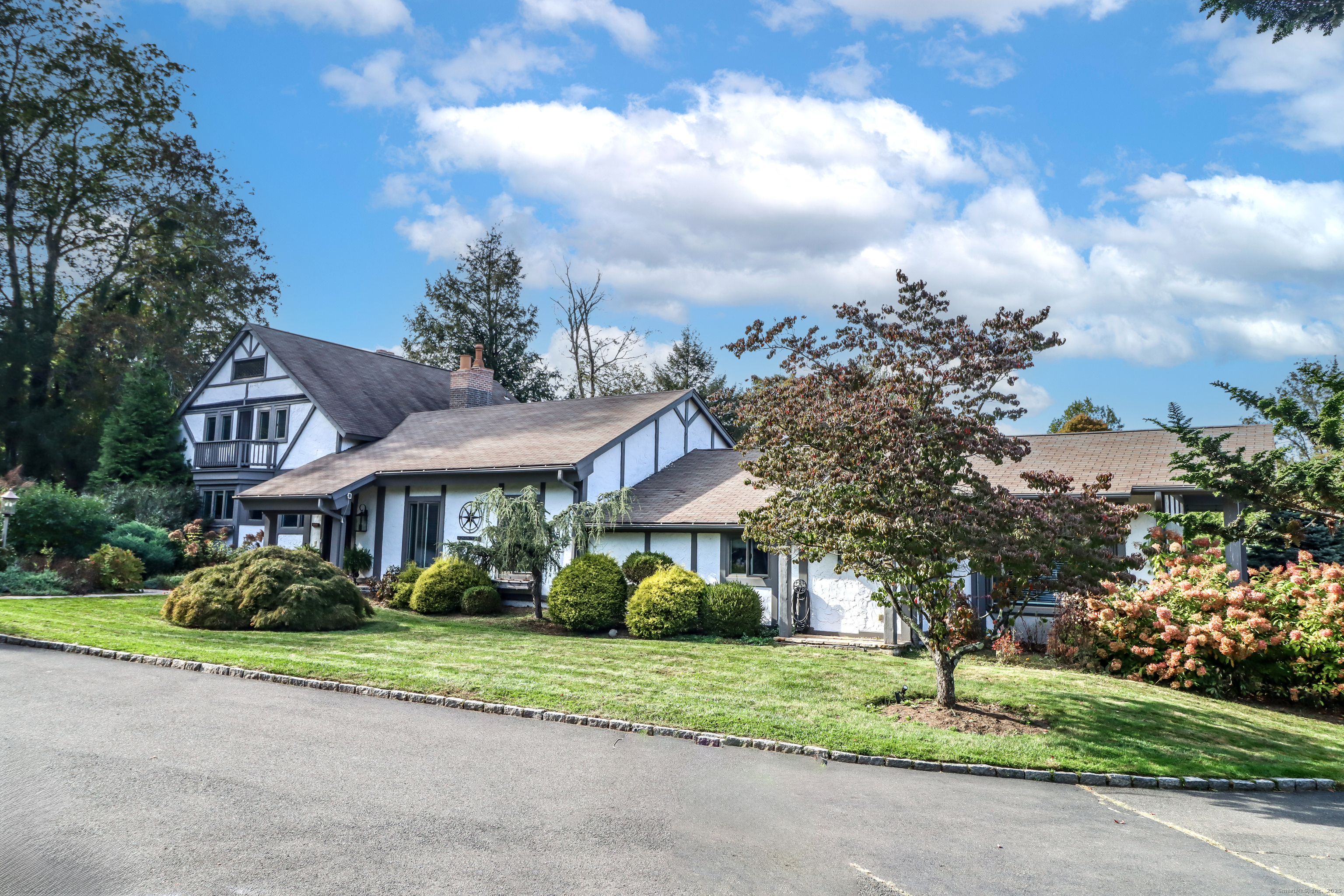70 Obtuse Hill Road Brookfield, CT 06804 - Photo 35 of 37 a front view of a house with a garden and trees