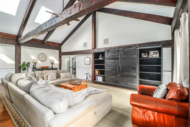 a bedroom with furniture and a large window