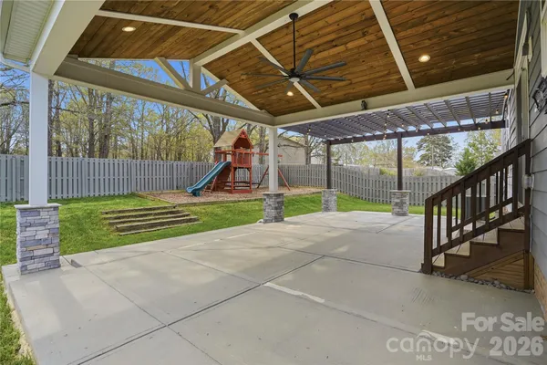a view of a yard with a large tree