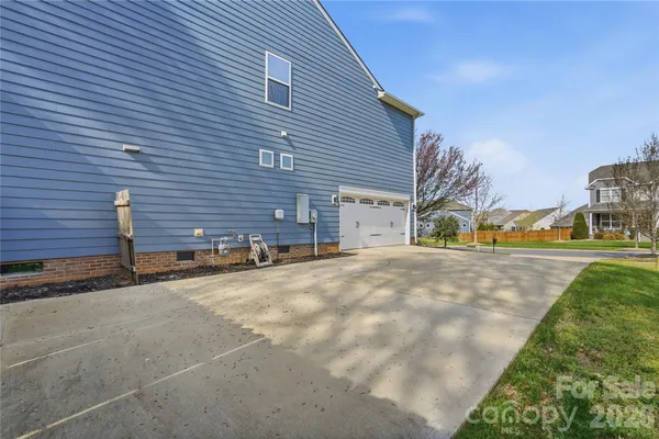 a view of a dining room with furniture a chandelier and wooden floor
