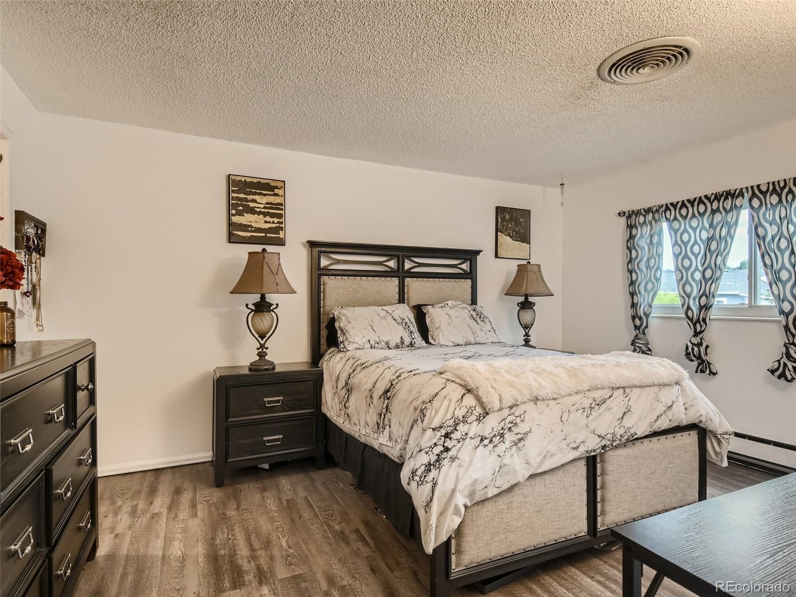 11111 Hudson Place Thornton, CO 80233 - Photo 14 of 28 a bedroom with a bed and a tv on table