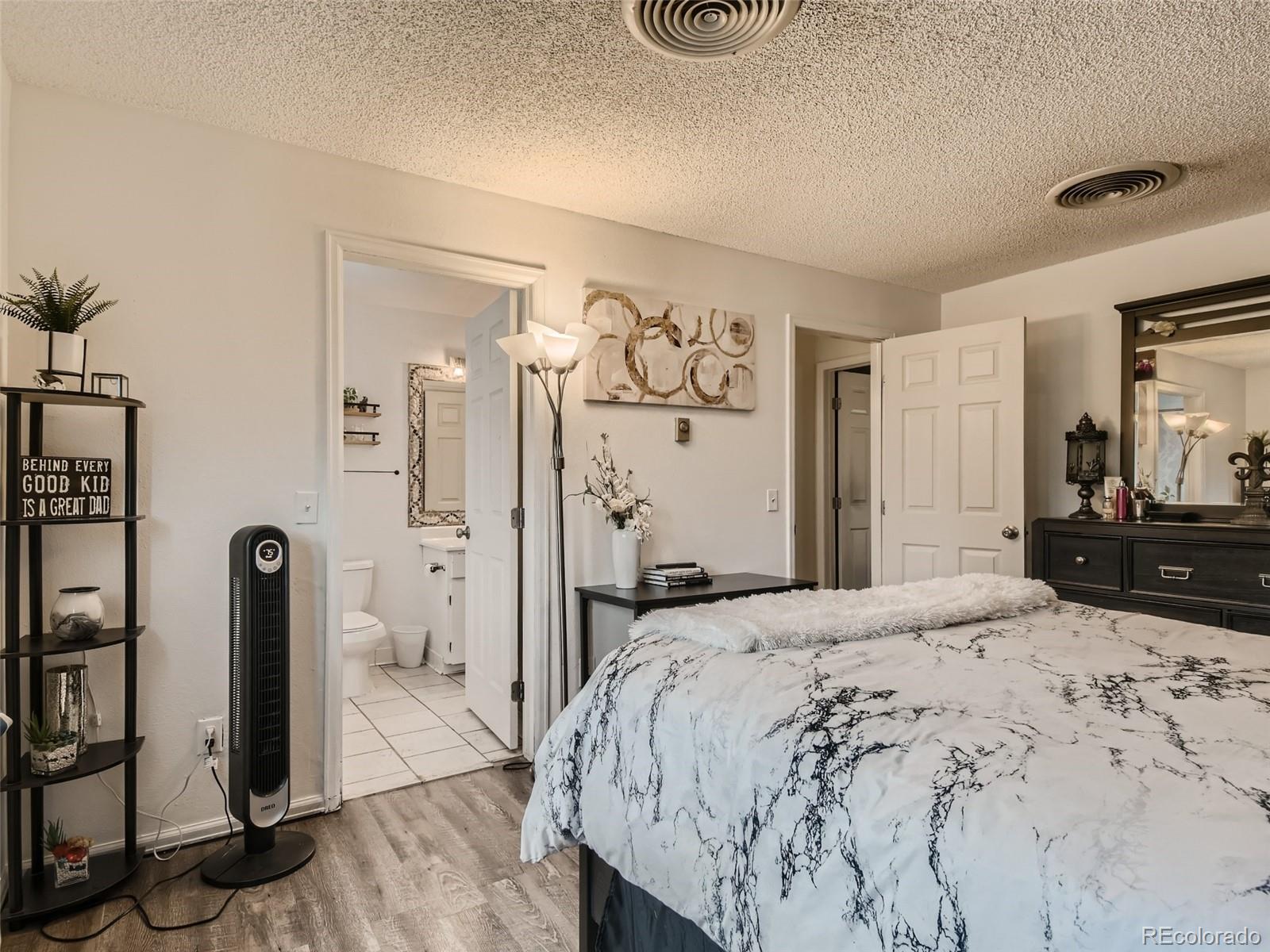 11111 Hudson Place Thornton, CO 80233 - Photo 16 of 28 a bedroom with a bed and a mirror