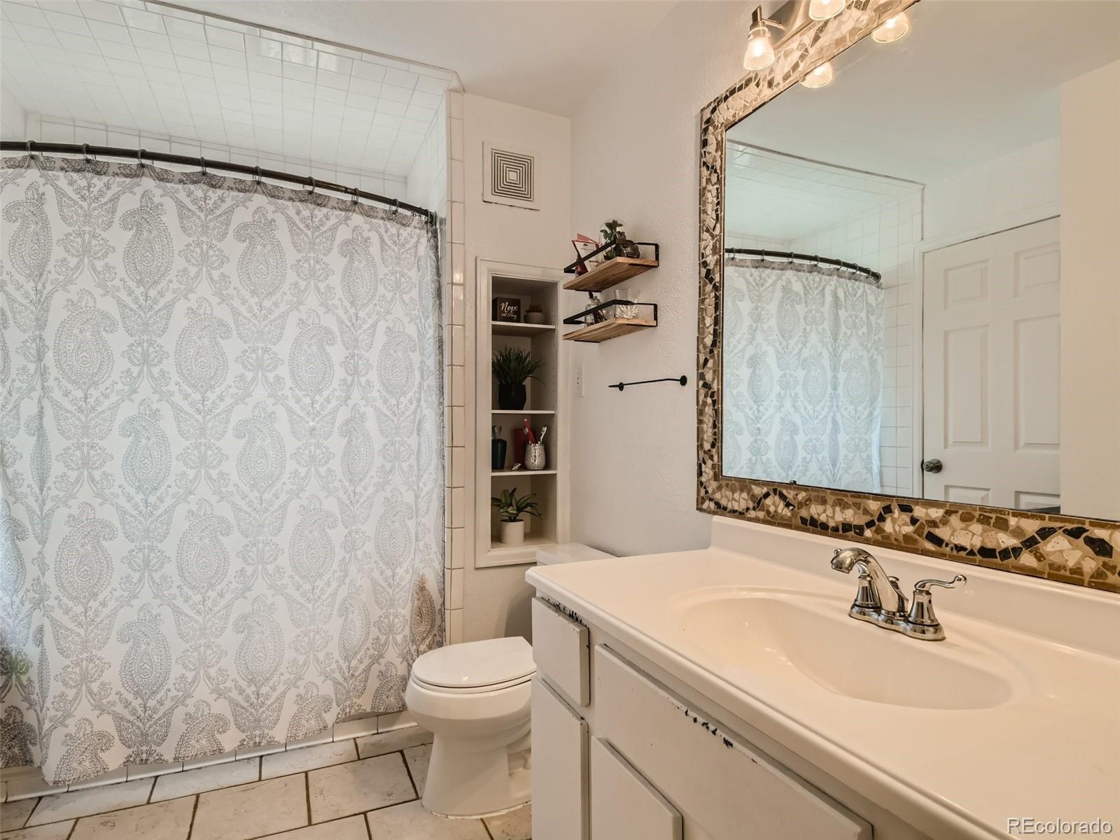 11111 Hudson Place Thornton, CO 80233 - Photo 17 of 28 a bathroom with a sink and a mirror