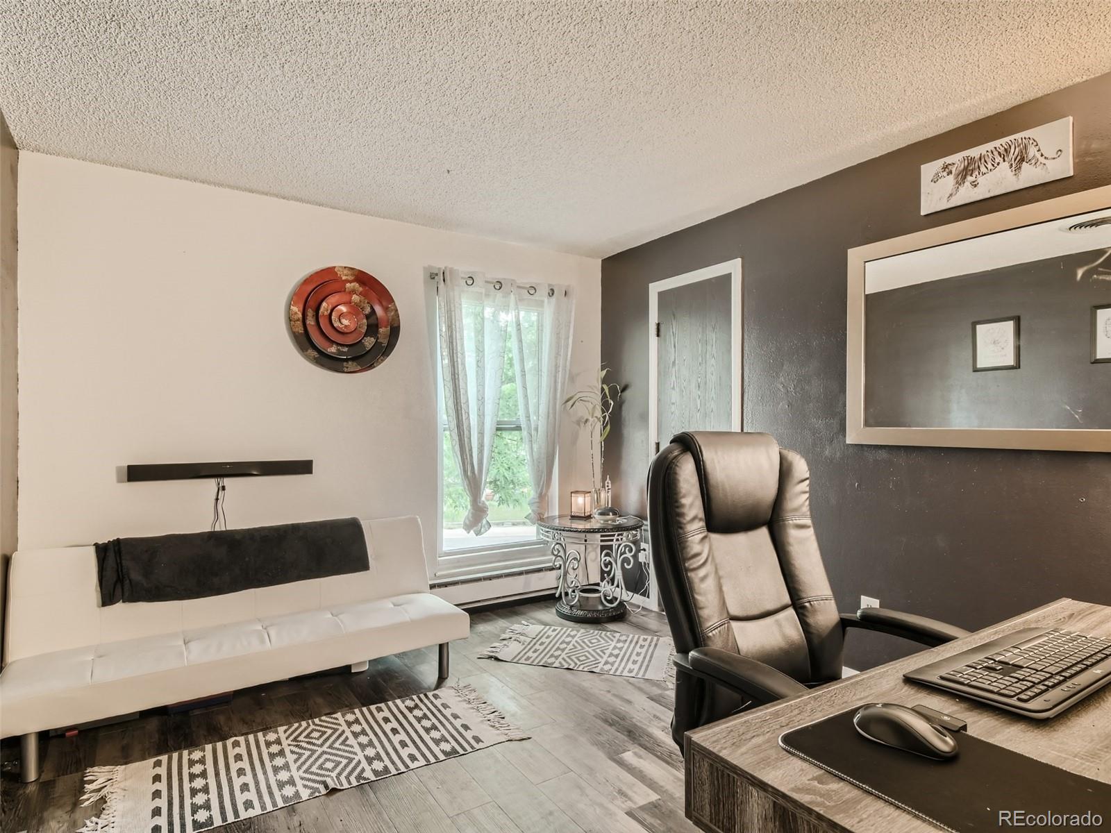 11111 Hudson Place Thornton, CO 80233 - Photo 19 of 28 a living room with furniture and a table