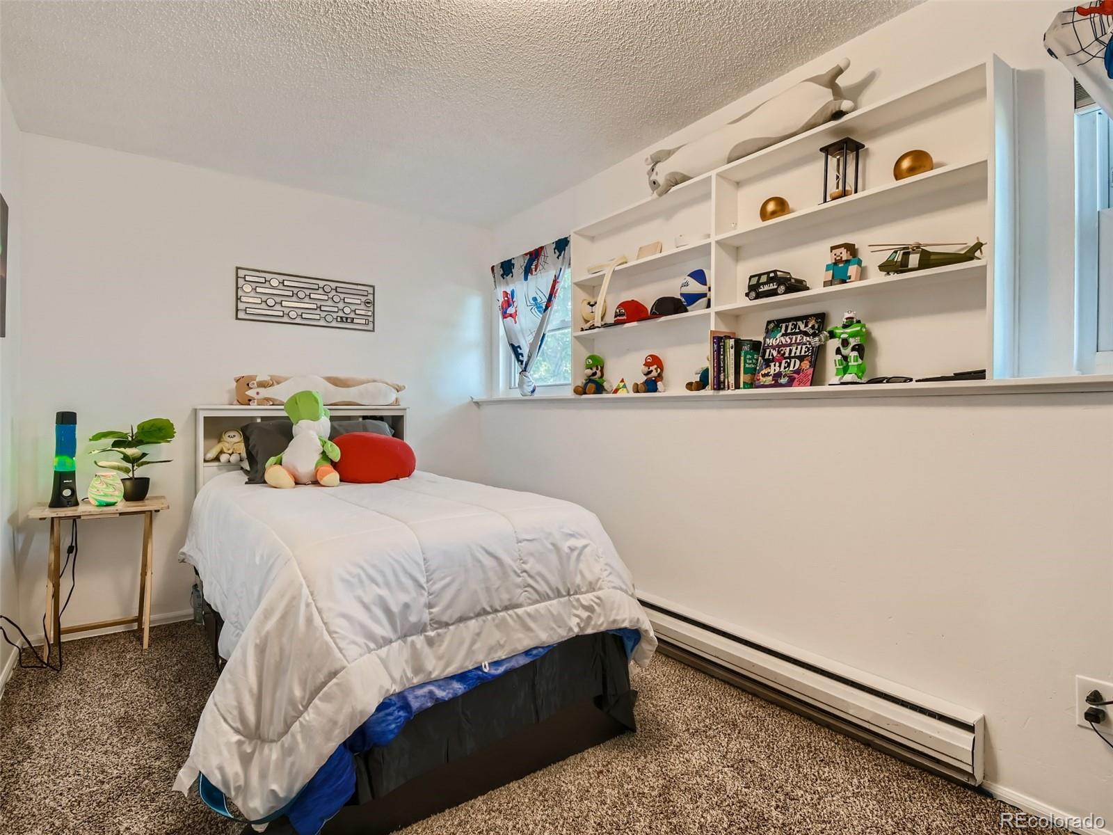 11111 Hudson Place Thornton, CO 80233 - Photo 21 of 28 a bedroom with a bed and dresser