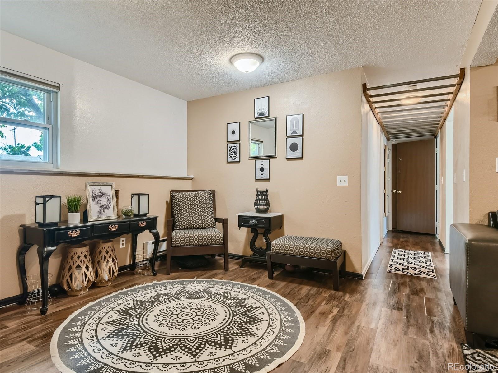 11111 Hudson Place Thornton, CO 80233 - Photo 25 of 28 a living room with furniture and wooden floor