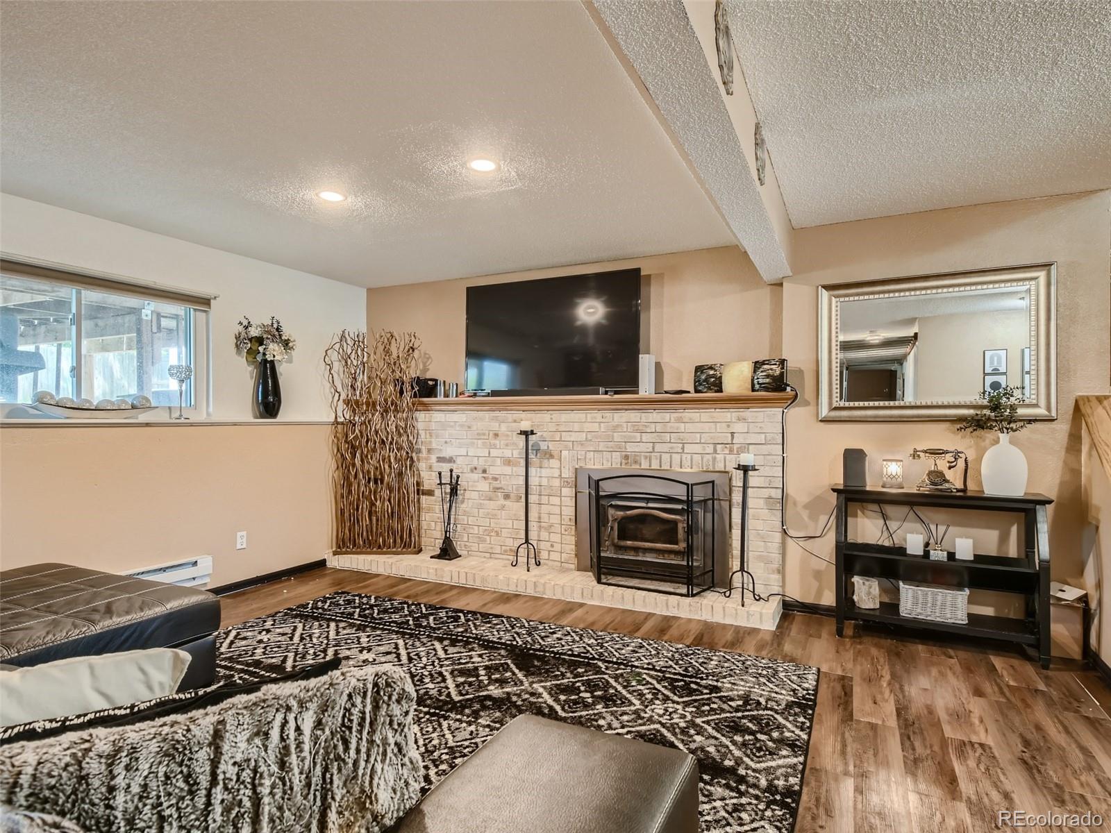 11111 Hudson Place Thornton, CO 80233 - Photo 26 of 28 a living room with furniture and a flat screen tv