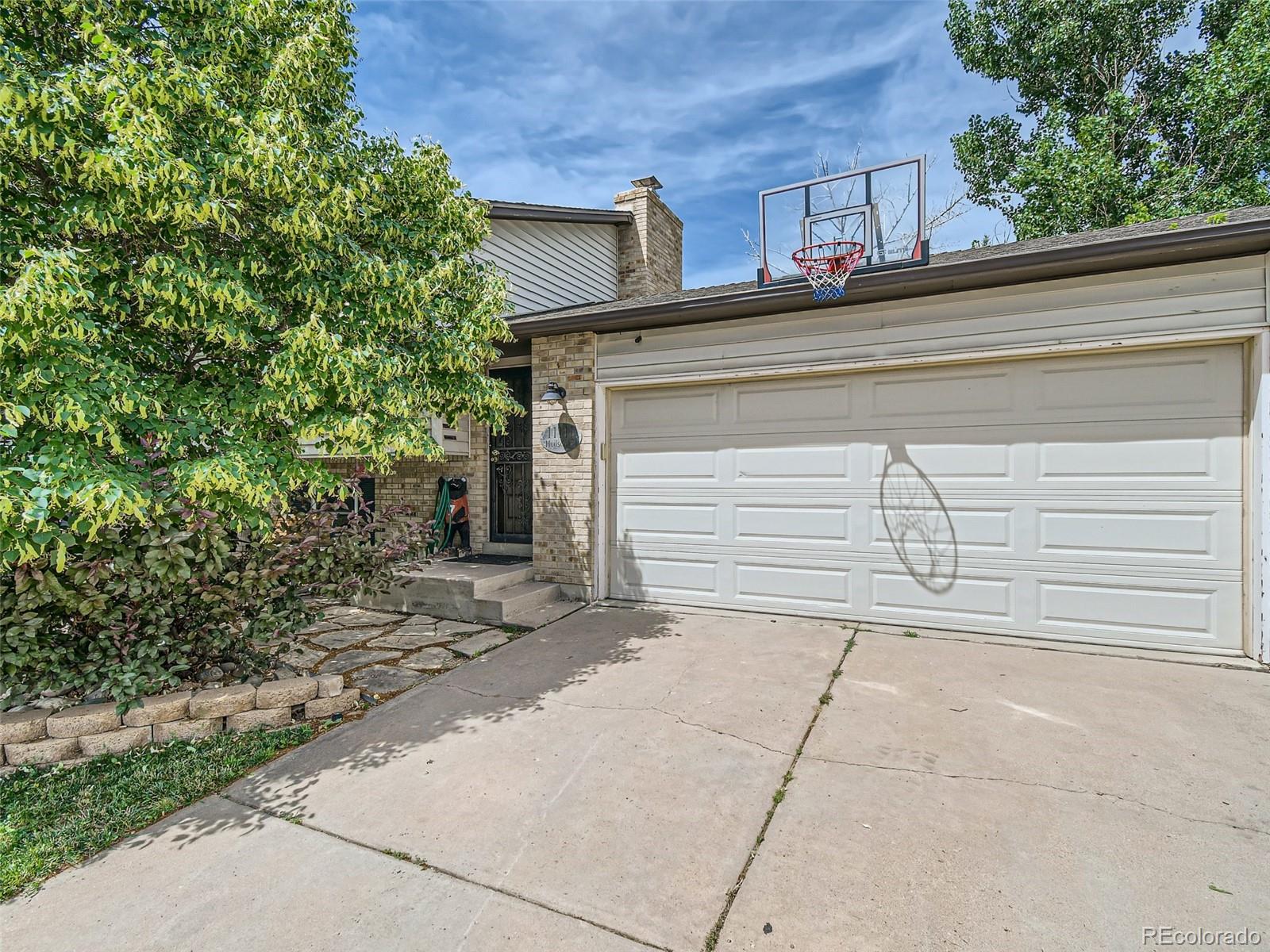 11111 Hudson Place Thornton, CO 80233 - Photo 3 of 28 a view of a house with a garage