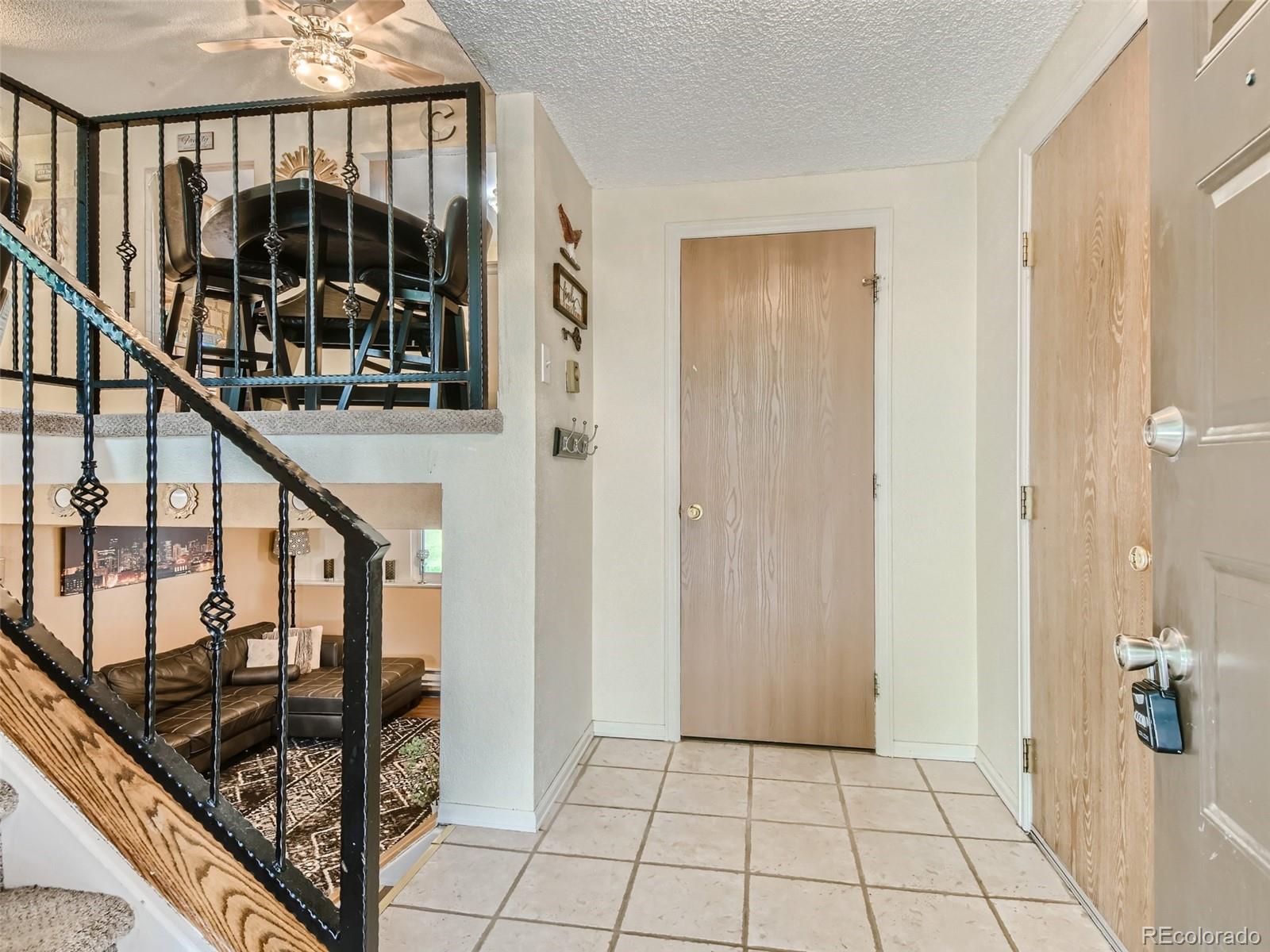 11111 Hudson Place Thornton, CO 80233 - Photo 4 of 28 a view of a hallway with wooden floor and staircase