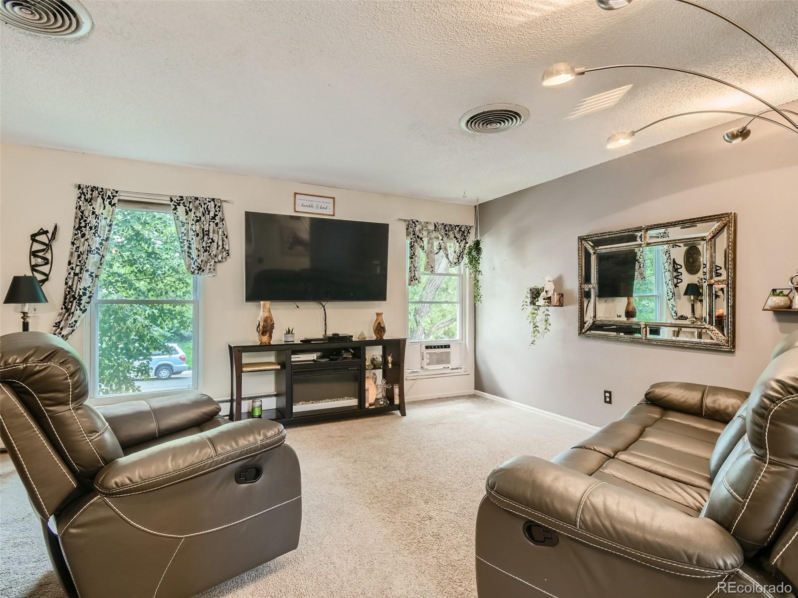 11111 Hudson Place Thornton, CO 80233 - Photo 6 of 28 a living room with furniture and a flat screen tv