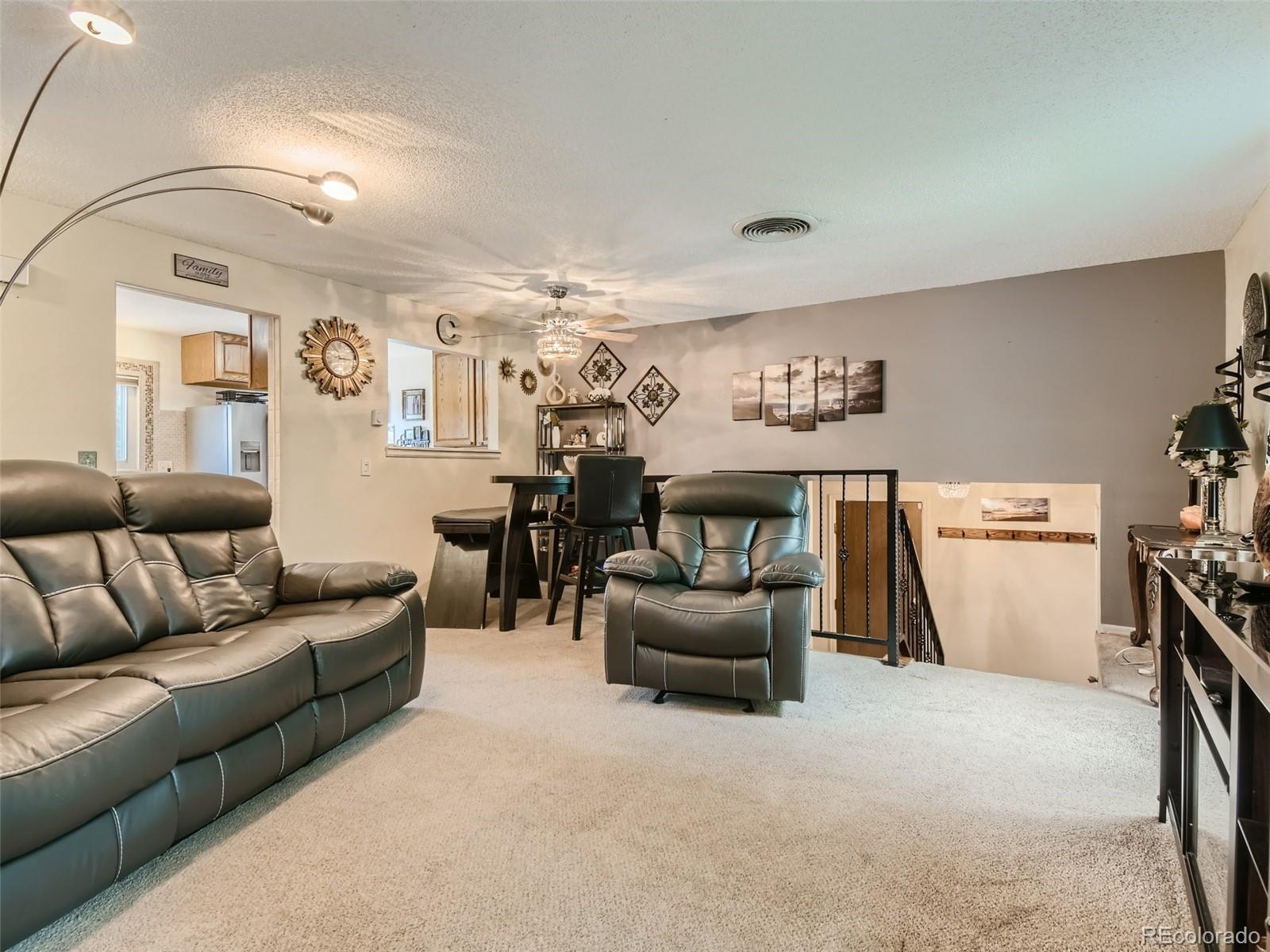 11111 Hudson Place Thornton, CO 80233 - Photo 7 of 28 a living room with furniture and a gym