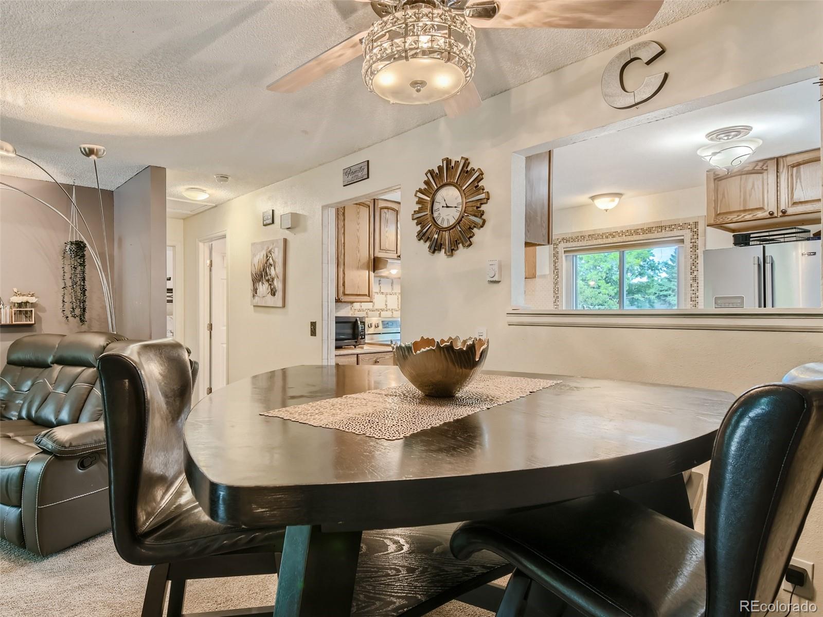 11111 Hudson Place Thornton, CO 80233 - Photo 8 of 28 a view of a dining room with furniture and wooden floor