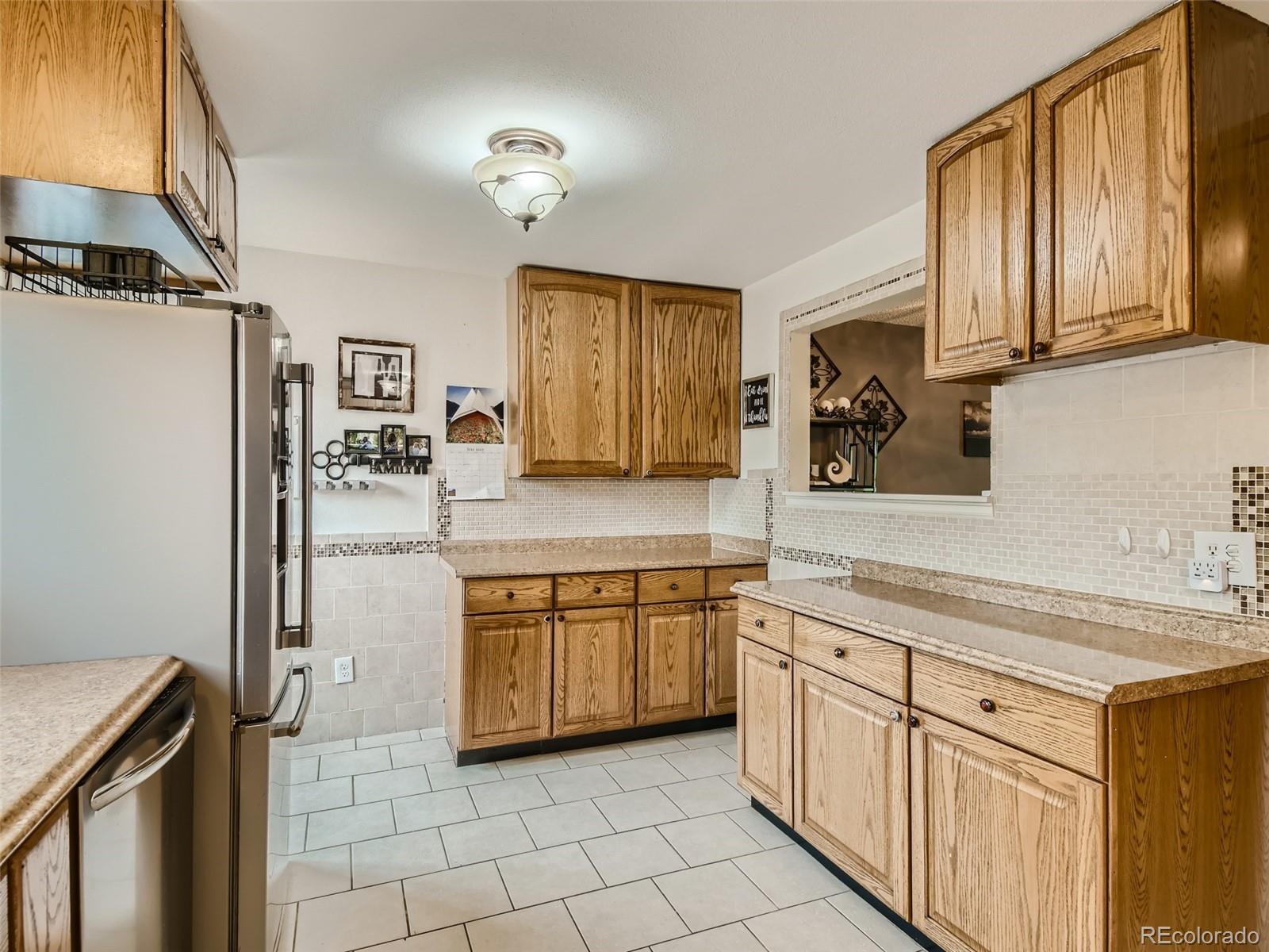 11111 Hudson Place Thornton, CO 80233 - Photo 10 of 28 a kitchen with stainless steel appliances granite countertop a refrigerator and a stove top oven