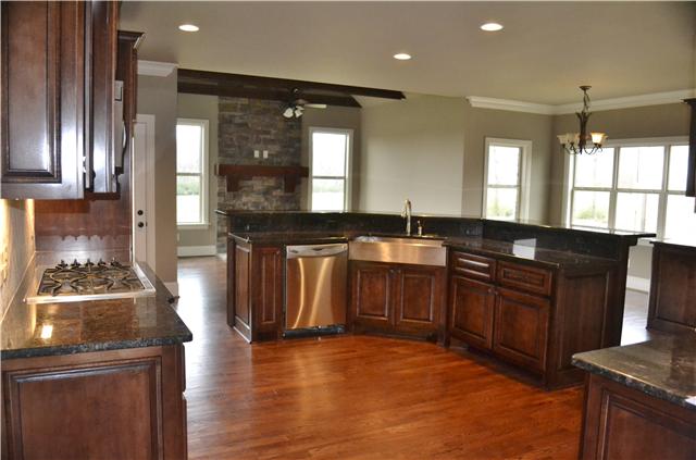 2073 Autumn Ridge Way Spring Hill, TN 37174 - Photo 5 of 20 Kitchen w/ sink island; under cabinet lighting; Eat-in area; Buffet/Hutch; Hearth or Keeping room w/ fireplace!