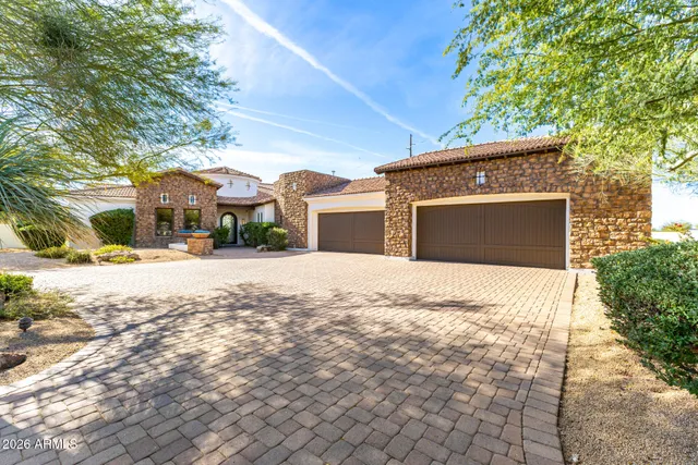 a kitchen with stainless steel appliances kitchen island granite countertop a table and chairs in it