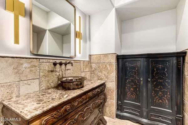 a bathroom with a granite countertop sink a toilet and a mirror