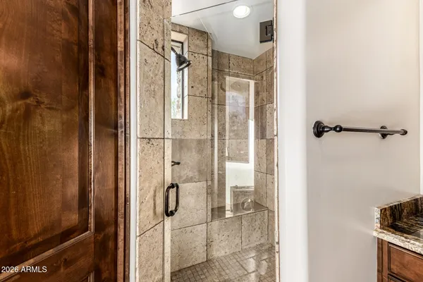a bathroom with a sink a toilet a mirror and shower curtain