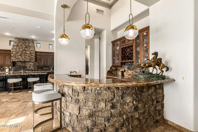 a dining room with furniture a chandelier and window