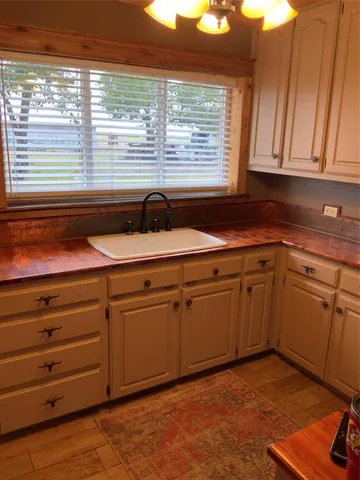 a kitchen with granite countertop cabinets and white appliances