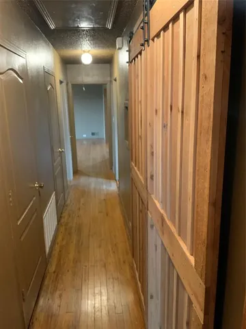 a view of a hallway with wooden floor